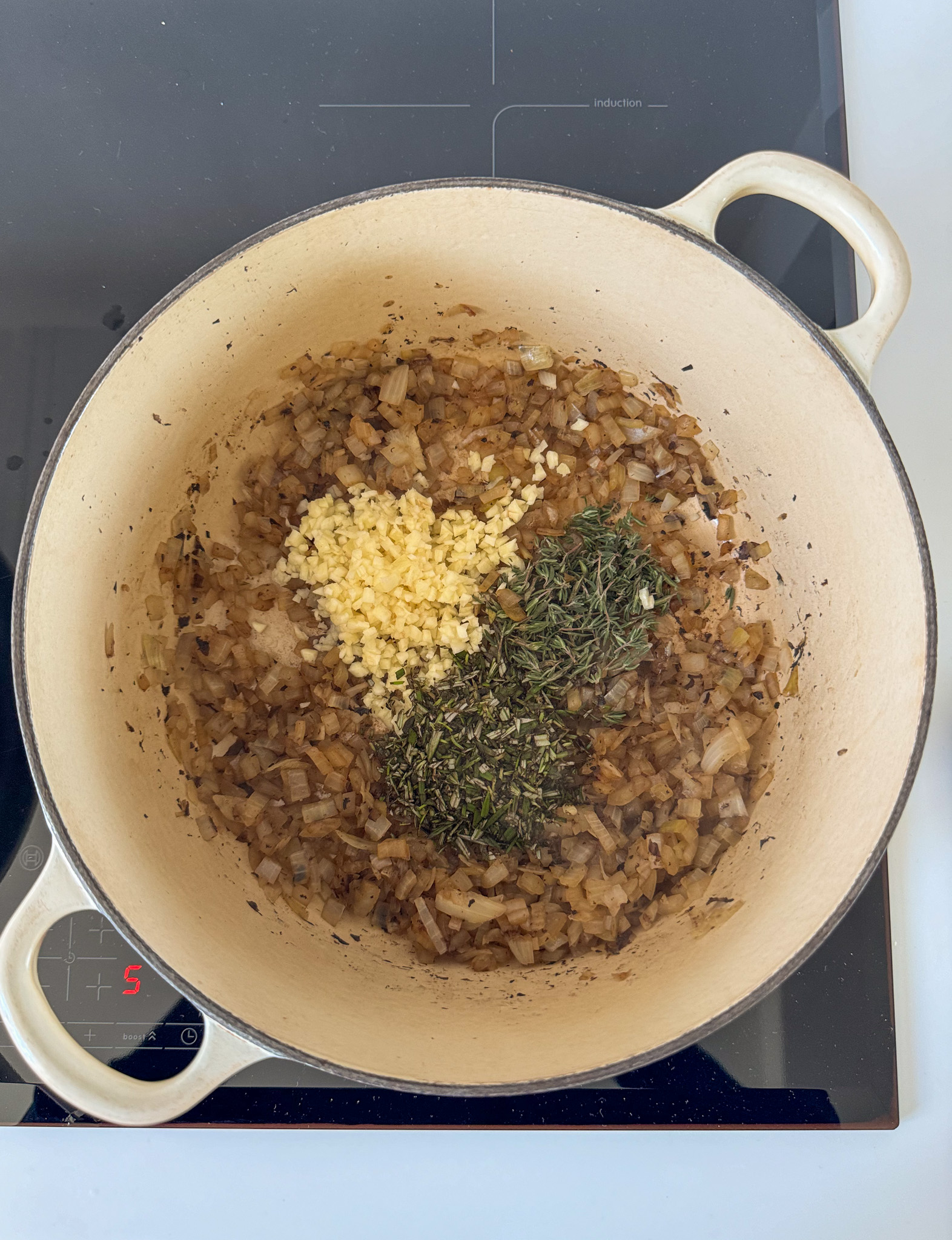 Onions, Garlic and herbs cooking on a Dutch hot pan