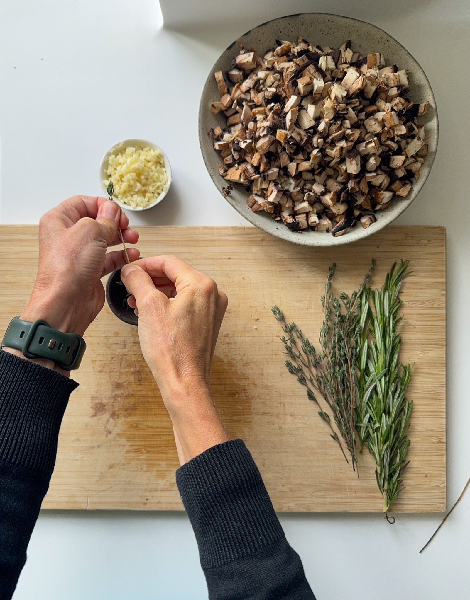 A bowl of cut Mushrooms, Garlic, Thyme and Rosemary