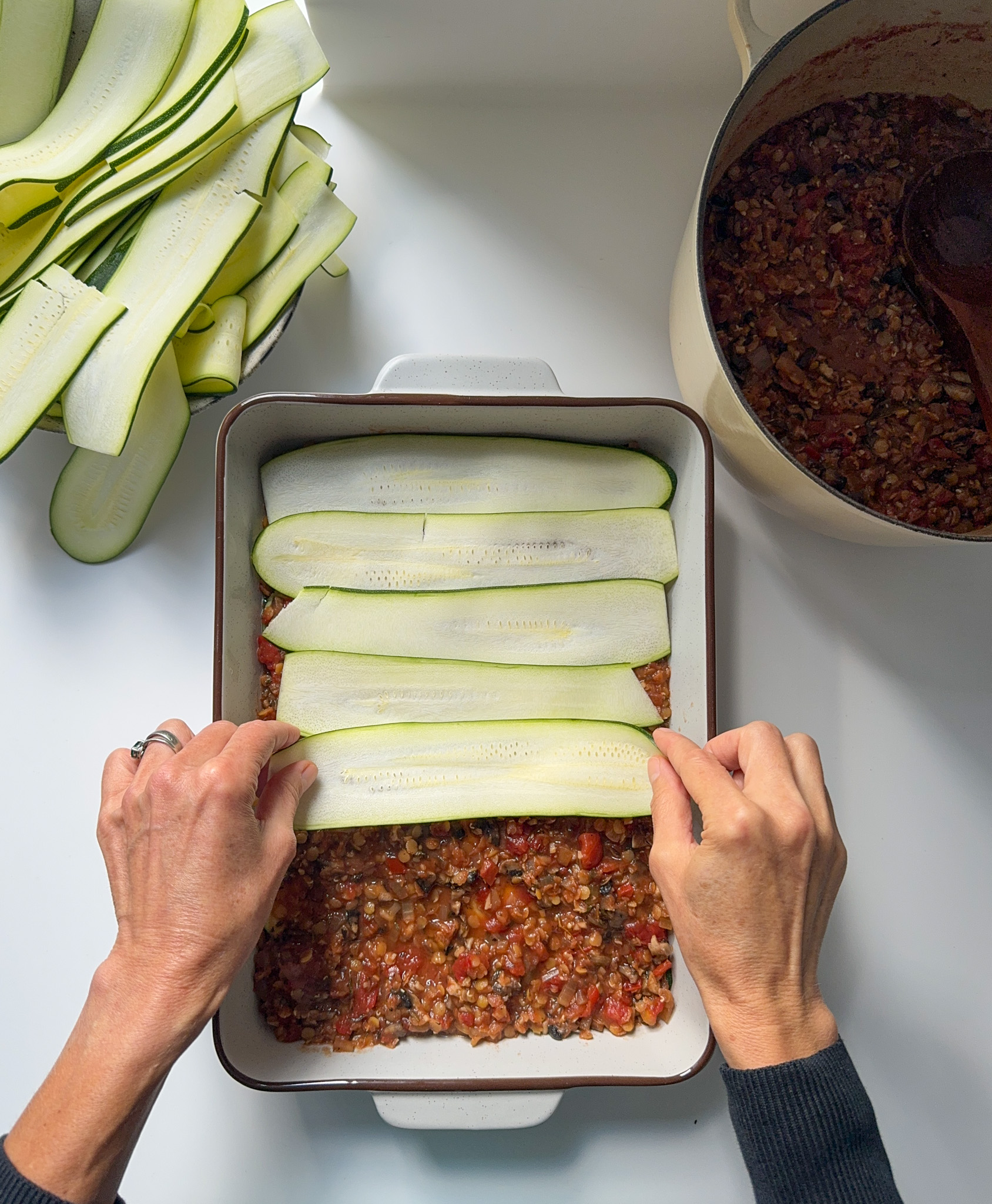 Lasagne being layered with courgette