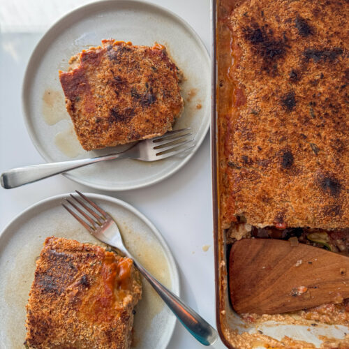 Vegan Lasagne trey and 2 squares on a plate.