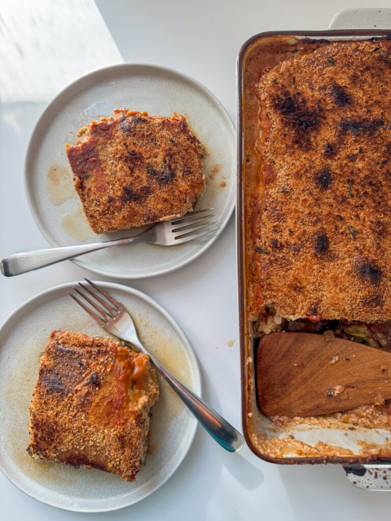 Vegan Lasagne trey and 2 squares on a plate.