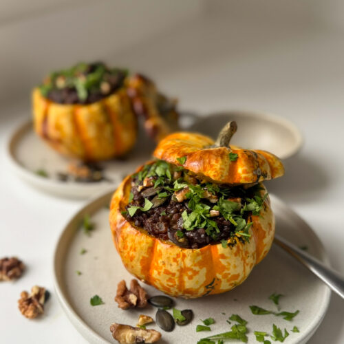 2 roasted pumpkins, stuffed with smoked beluga lentils in 2 small plates springle with parsley