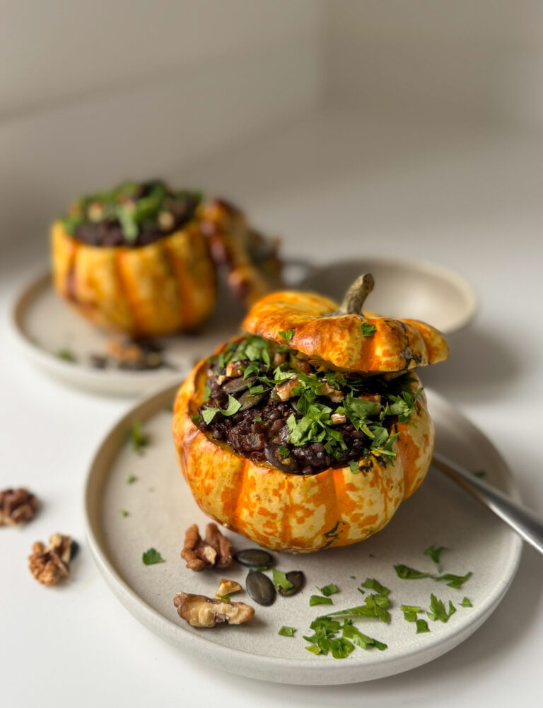 2 roasted pumpkins, stuffed with smoked beluga lentils in 2 small plates springle with parsley