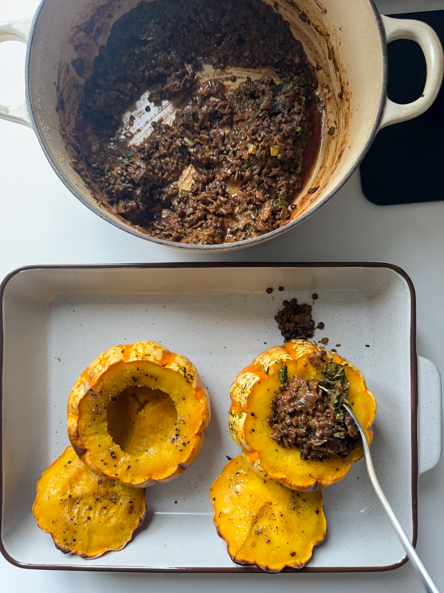 2 little pumpkins being stuffed with smoked beluga lentils