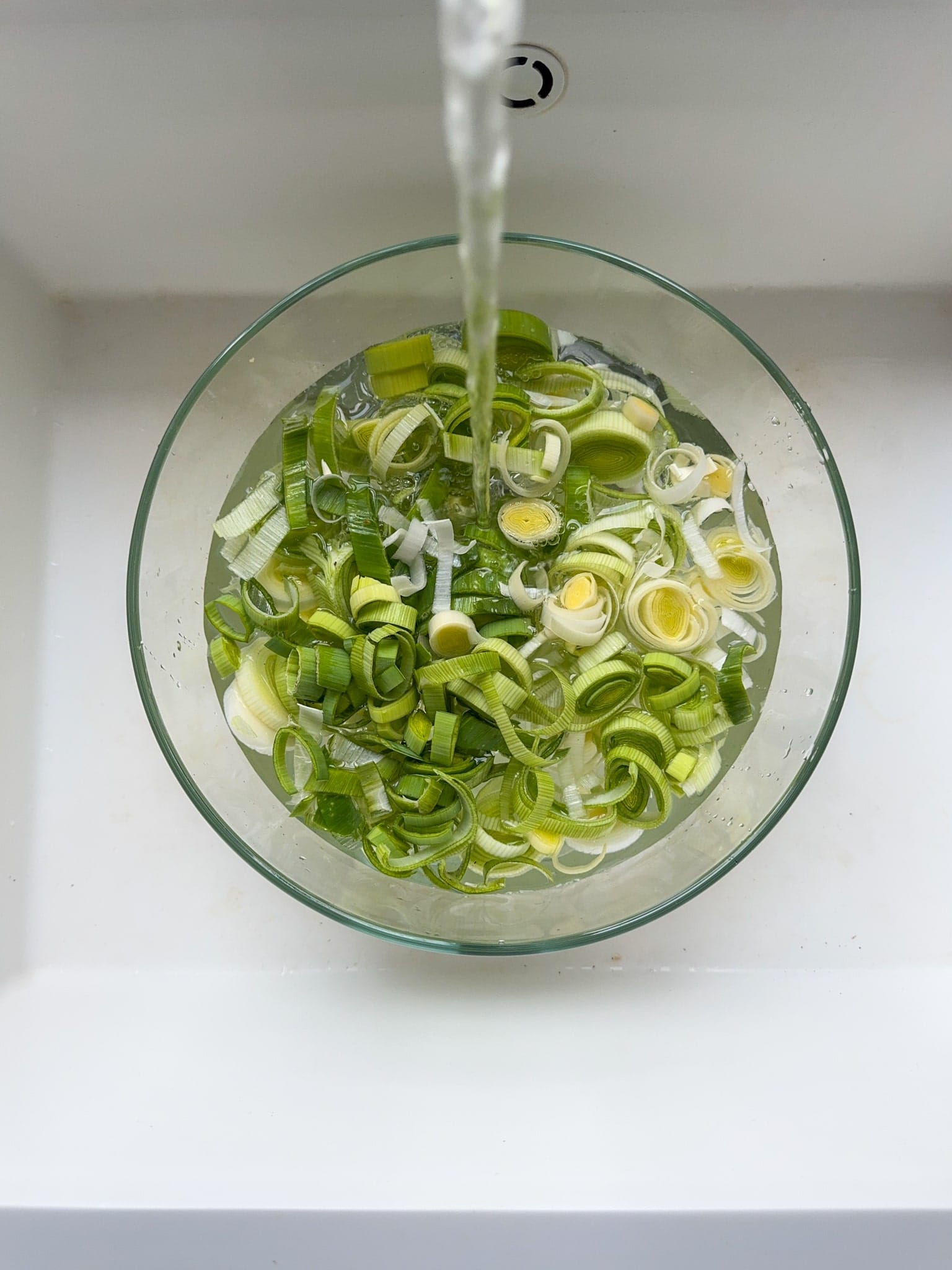 Cut Leeks being watch in a big glass bowl