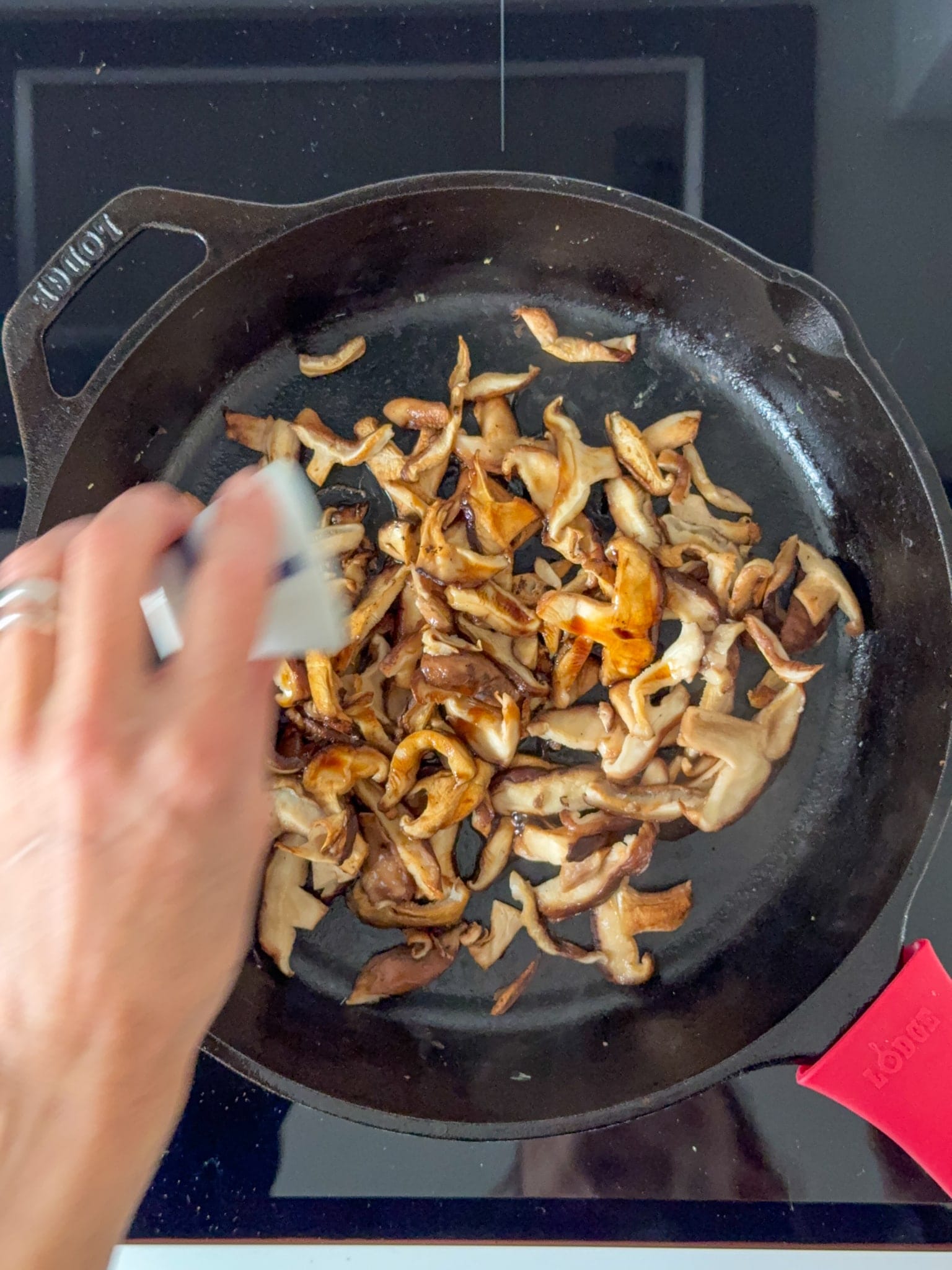 Shiitake Mushrooms being saute in a Iron cast pan