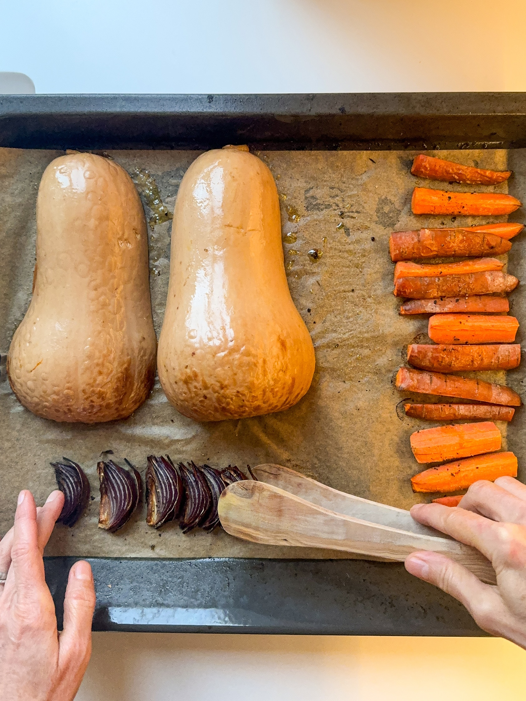 Butternut squash, carrots and red onions on a oven tray