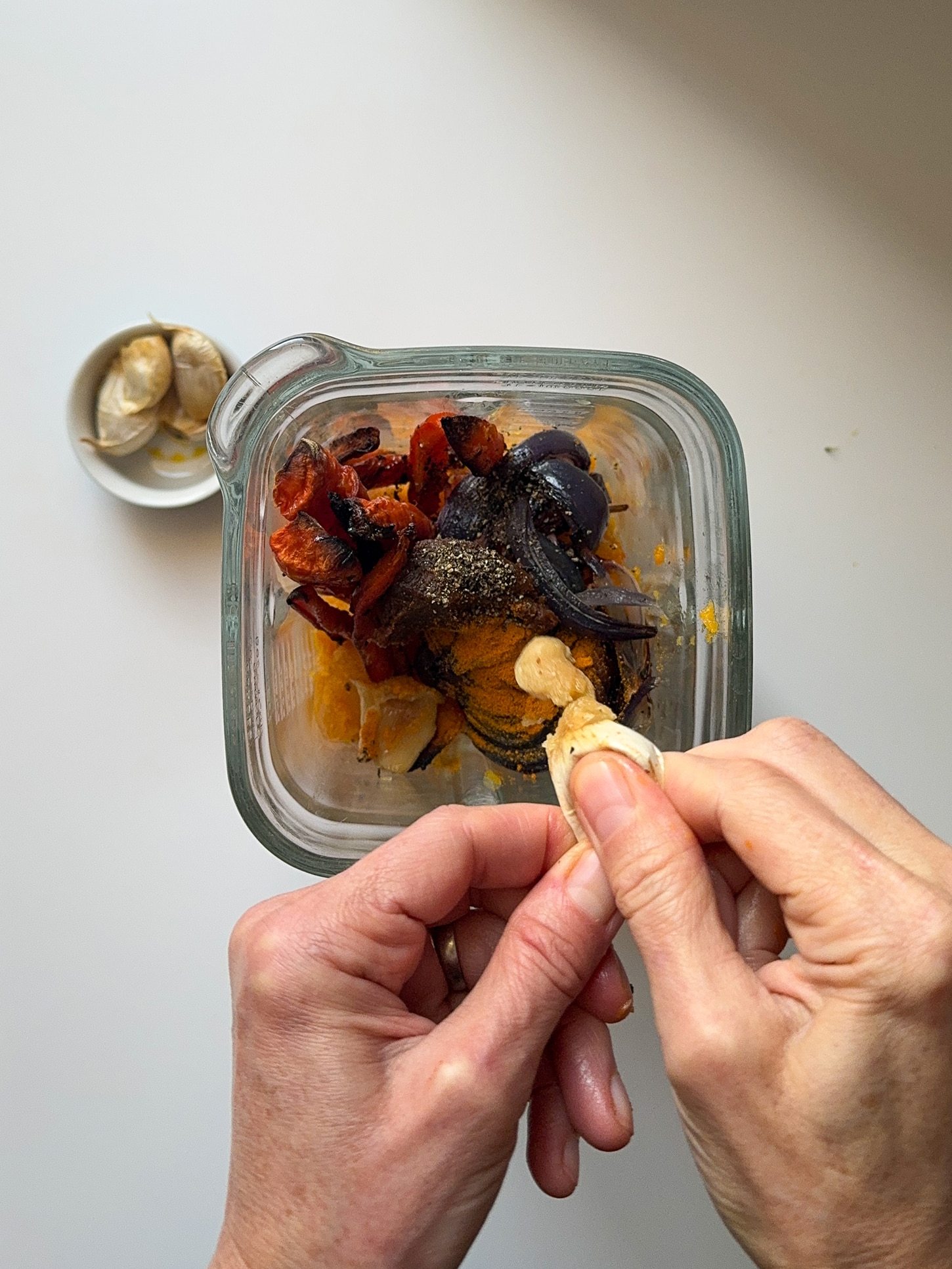 Roasted squash, red onion, carrots and garlic in a blender glass jar