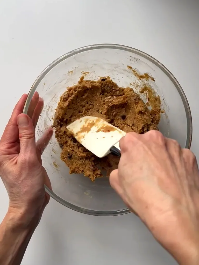 Mixing with a silicone spatula the Chickpea Chocolate Chip Cookies batter