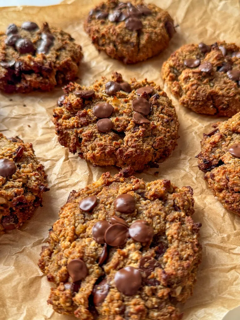 7 Chickpea Chocolate Chip Cookies on a light brown baking paper