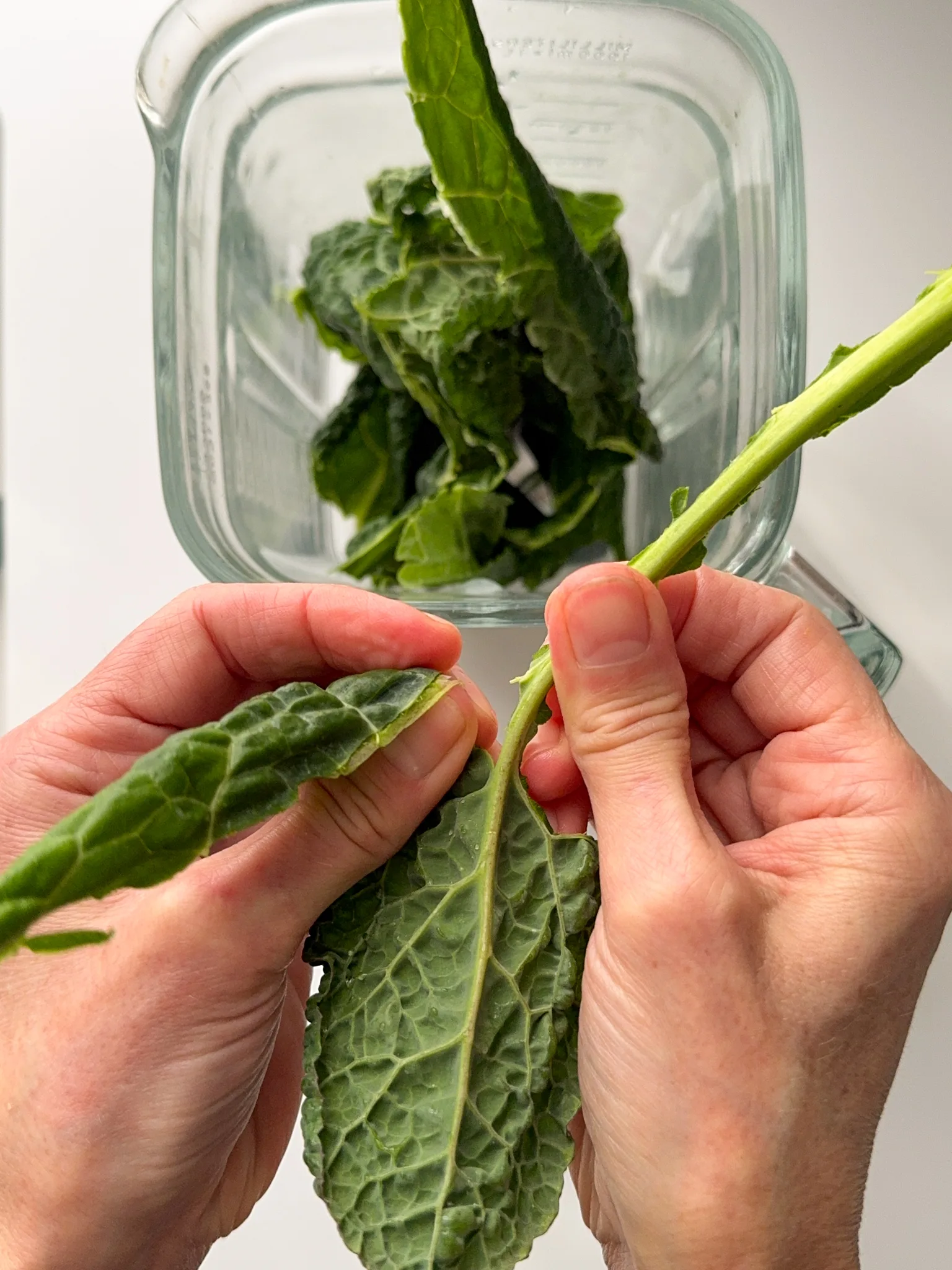 Separate a kale leaf from the stalk