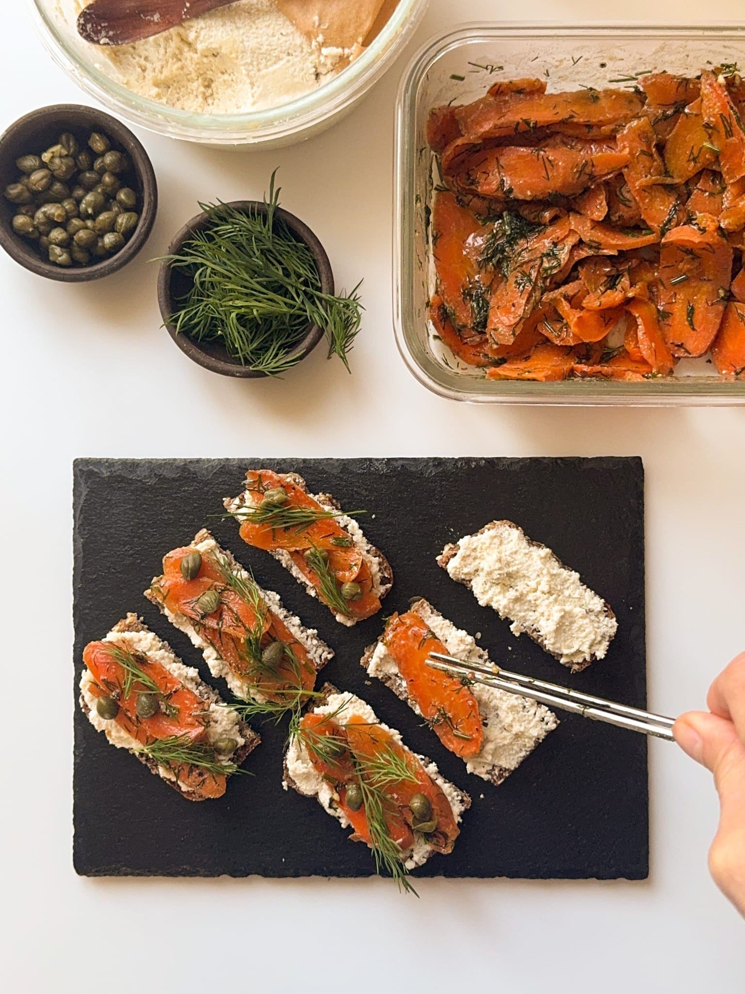 6 bits of rye bread topped with cream cheese and carrot lox
