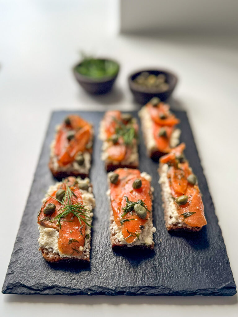 Smoked Carrot Lox on top of 6 small pieces of rye bread.
