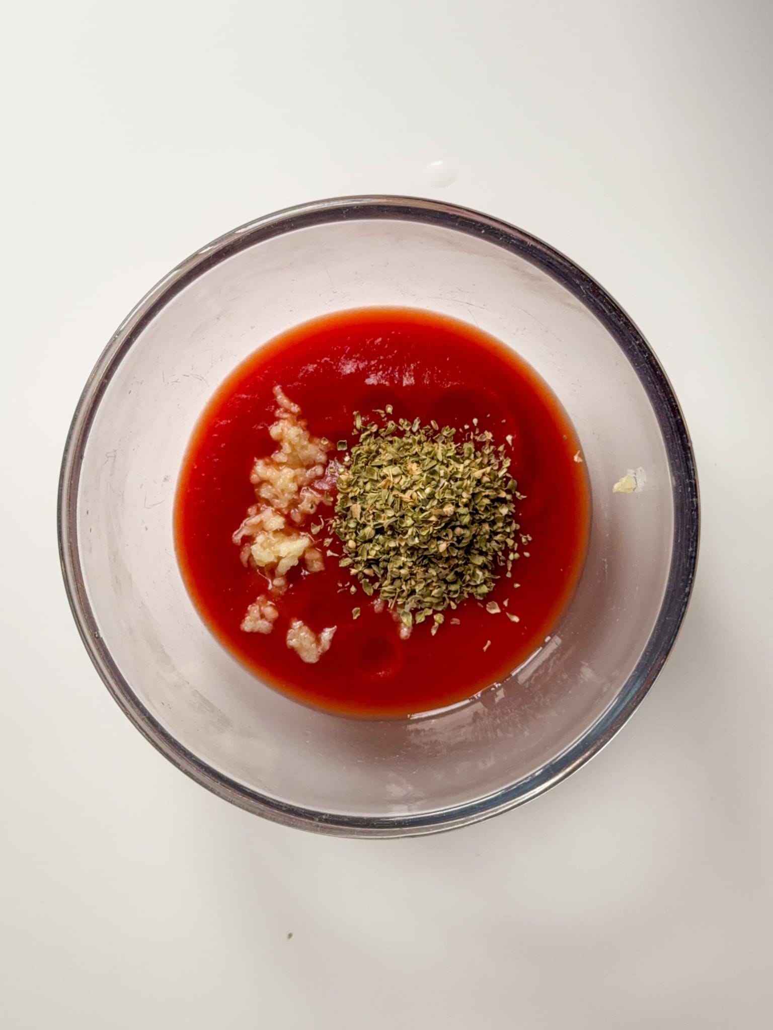 Passata, oregano and garlic in a bowl